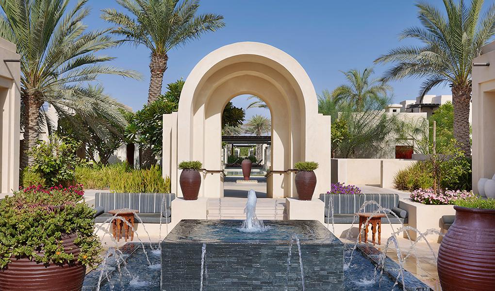 Stone pillars and running water in one of the village courtyards at Al Wathba