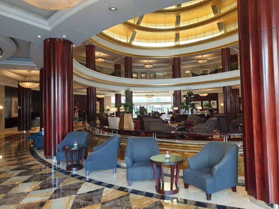 The domed lobby of Beach Rotana with circular seating beneath a high ceiling