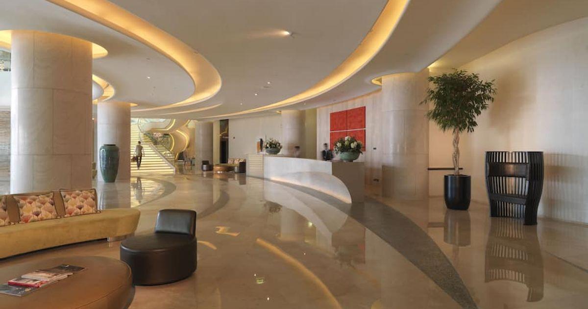 The lobby and reception desk at Millennium Al Rawdah Hotel