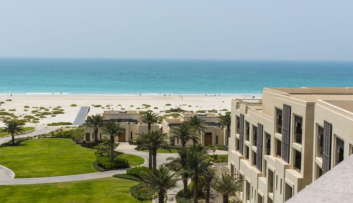 The low rise exterior of Park Hyatt Abu Dhabi seen from the beach