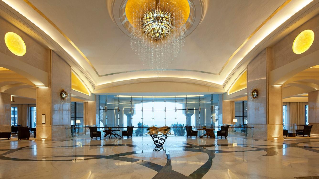 The lobby with its arched windows, columns and sightline to the water