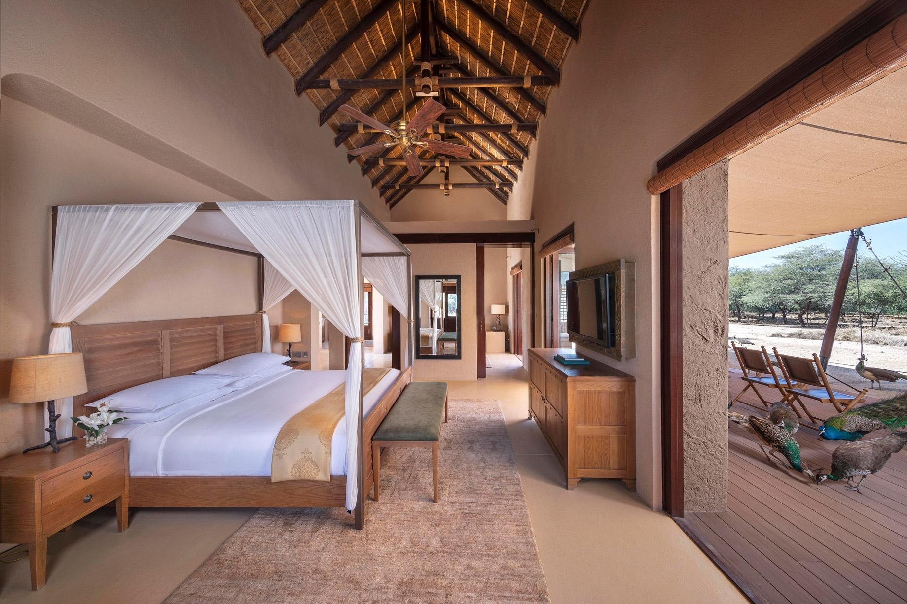 The interior of a wilderness pool villa, finished in timber, canvas and earth tones