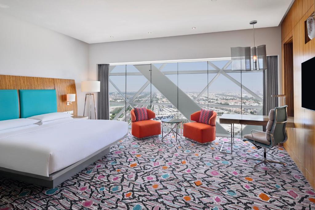 A guest room with floor to ceiling windows on the leaning face of the tower