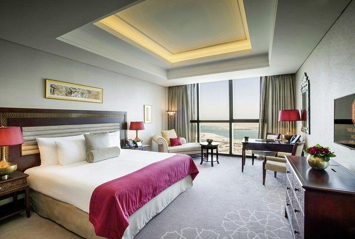 A sea view room with a panoramic window and seating area