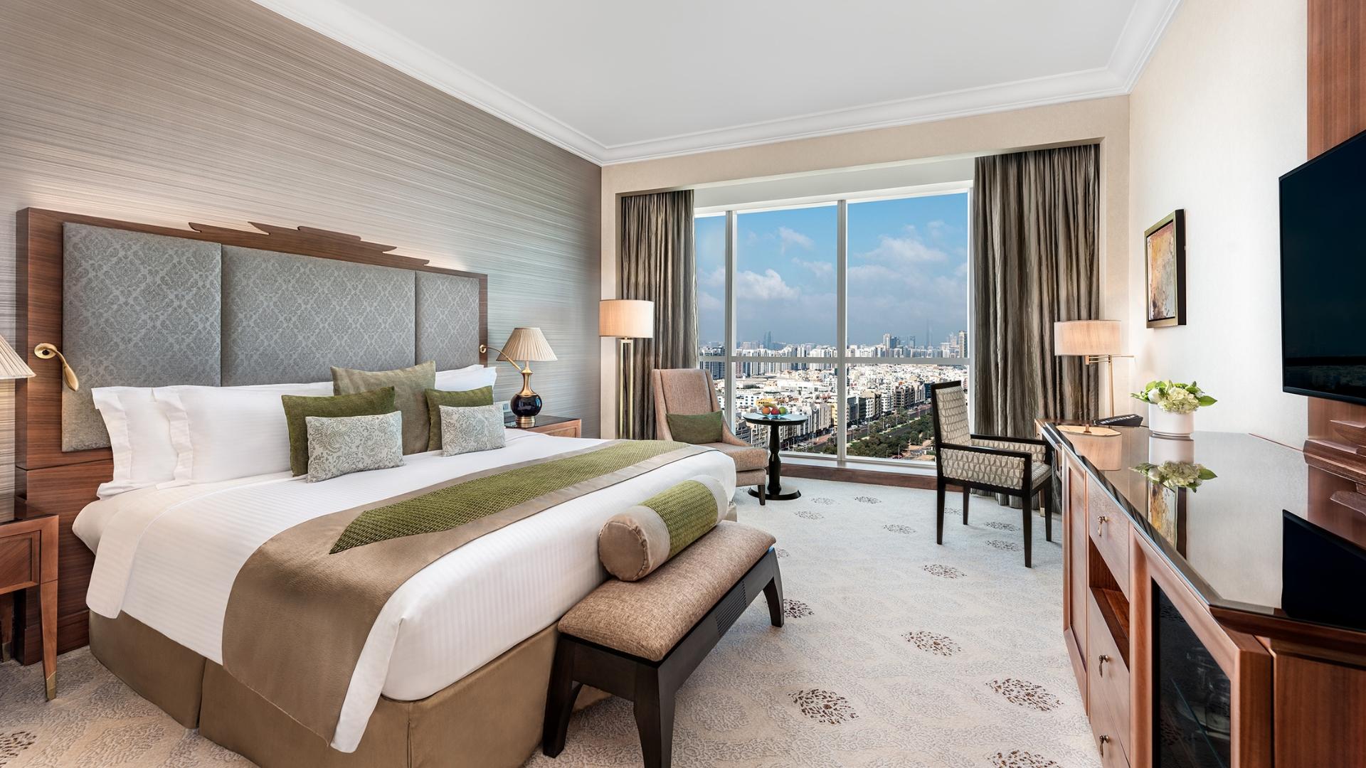 A 42 square metre deluxe room with city view, deep soaking tub and rainfall shower