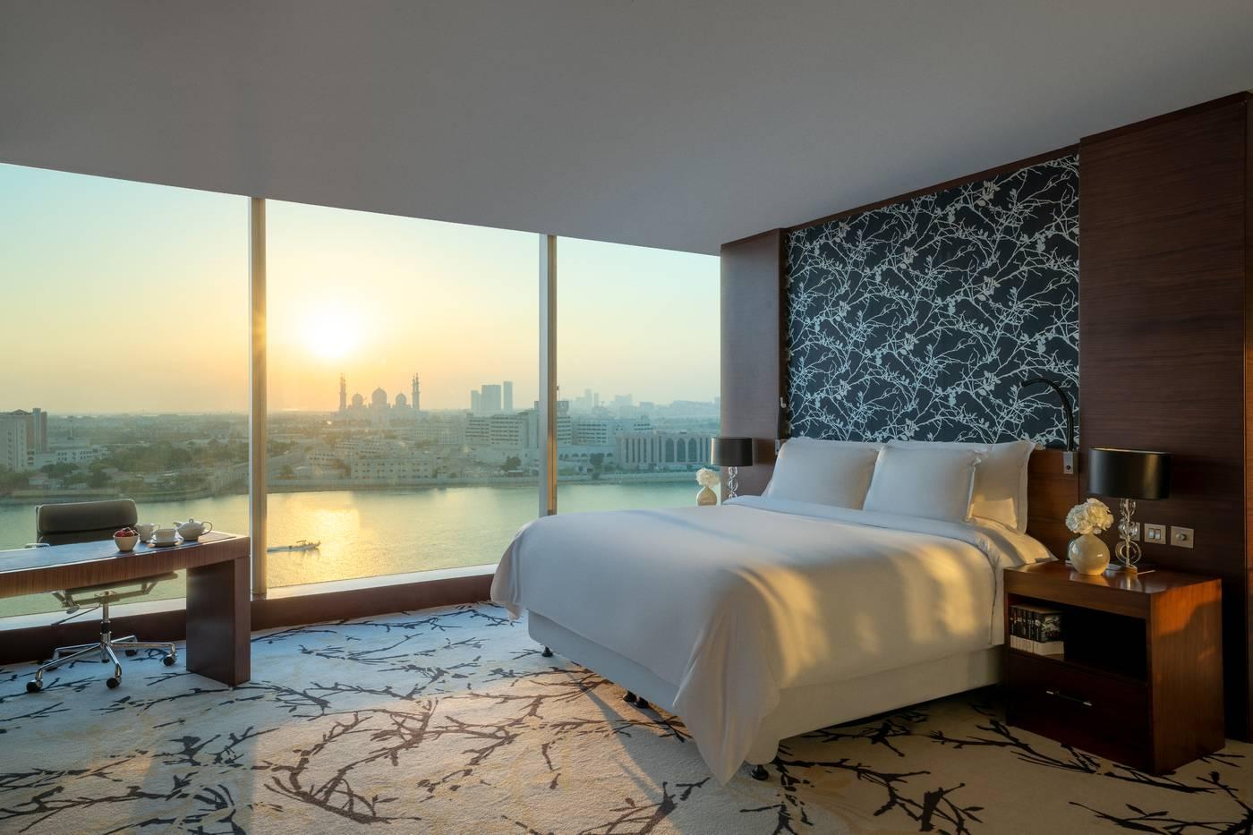 A creek view room with a private balcony facing the mosque