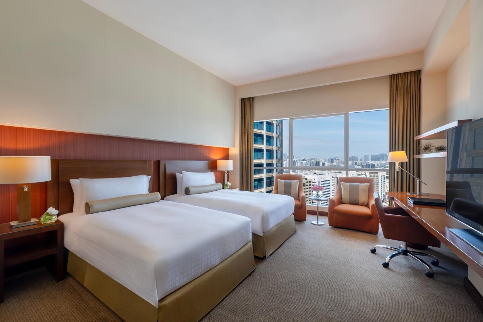 A 36 square metre deluxe room with a pillowtop bed and a city view
