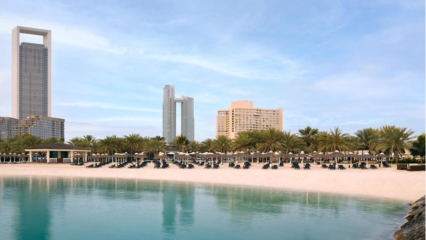 The private beach at Al Bateen with chairs, umbrellas and cabanas