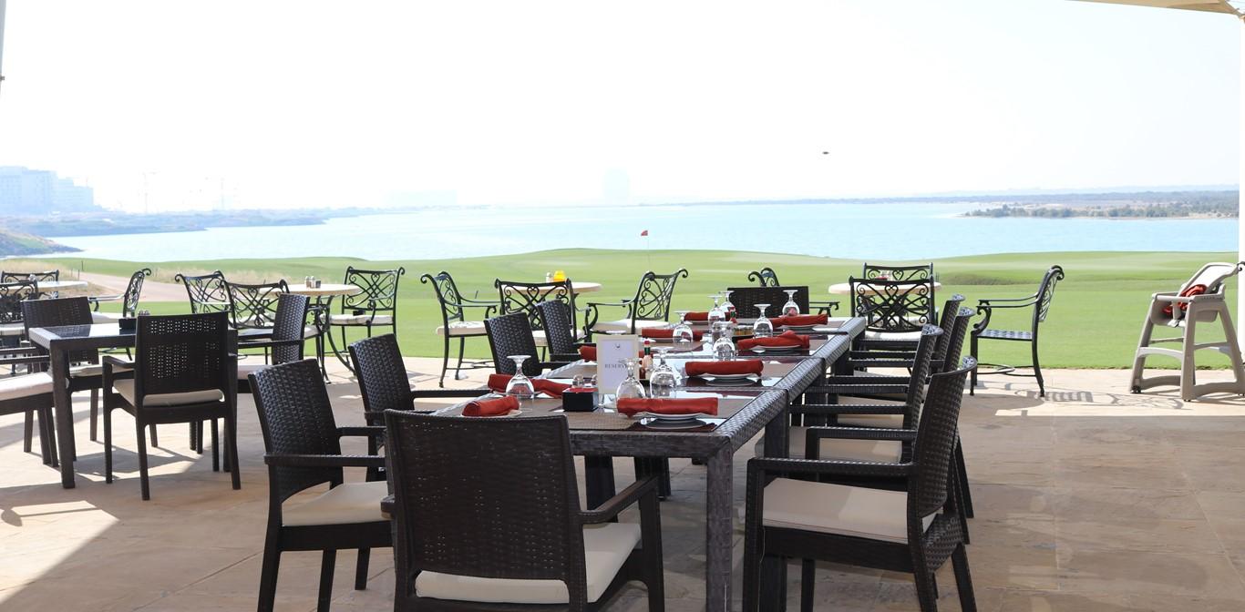 Jing Asia terrace overlooking Yas Links golf course and lagoon