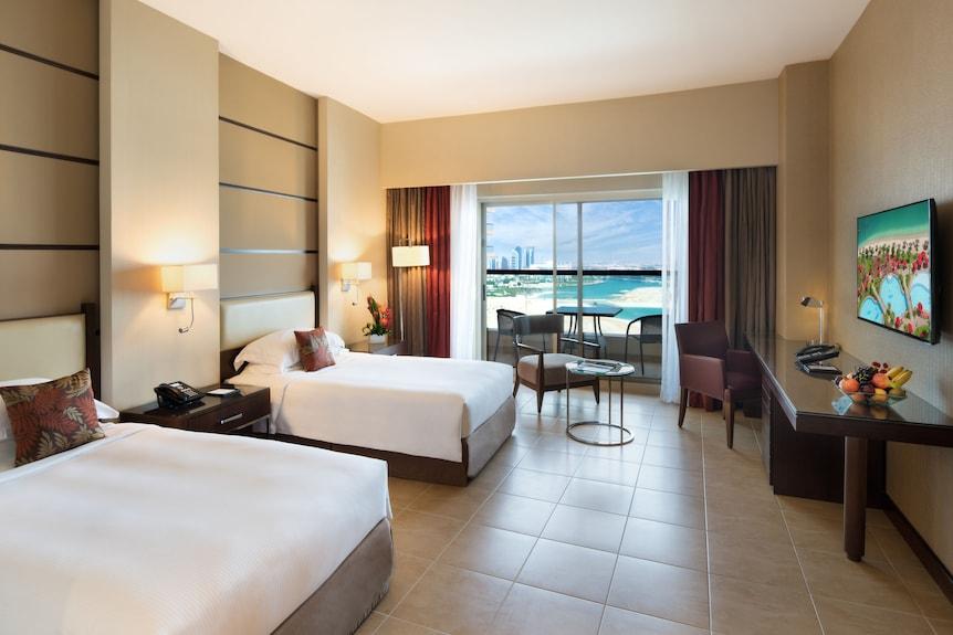 A family room with a balcony looking along the Corniche