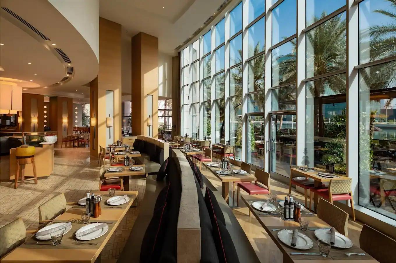 Prego's relaxed Italian dining room overlooking Beach Rotana gardens and sea