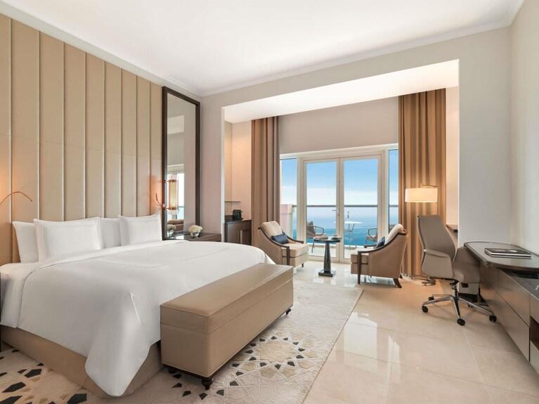 A deluxe room with a Corniche view and a private balcony