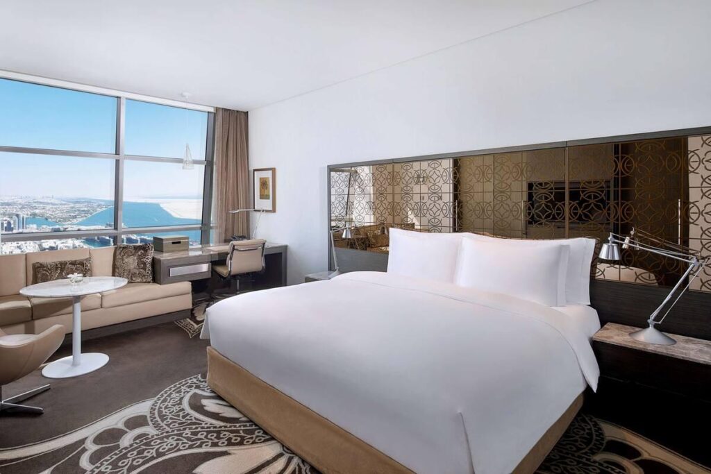 A sea view room with floor to ceiling glazing and a private balcony