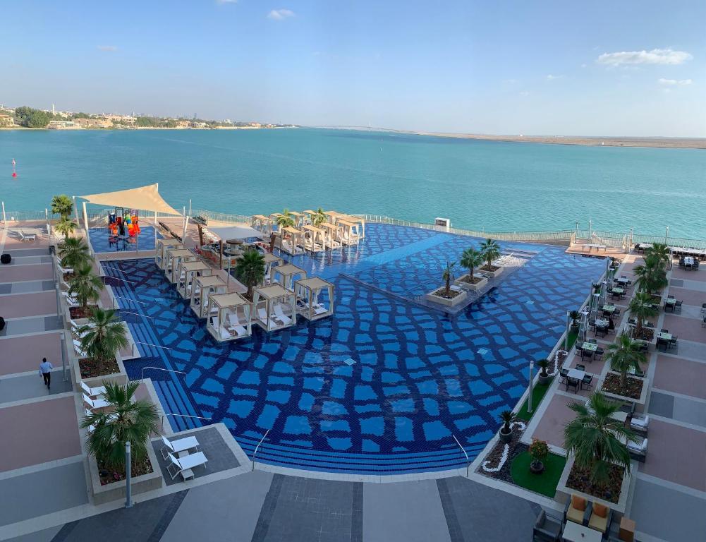 The outdoor pool and terrace set between the gardens and the sand