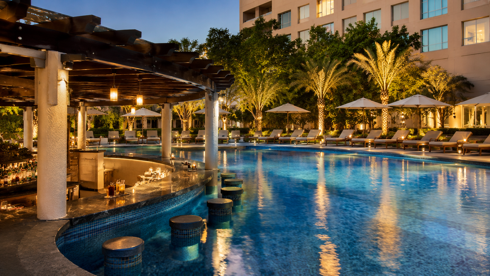 The outdoor pool and its swim up bar with loungers alongside
