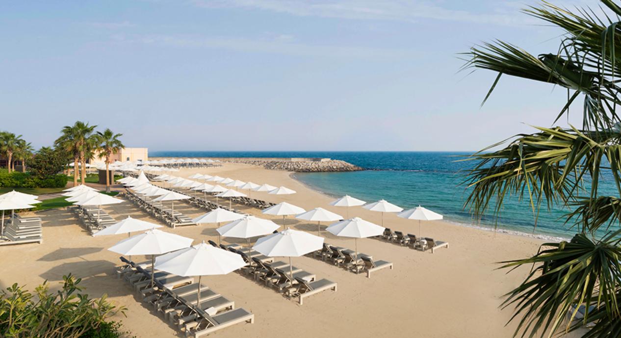 The private white sand beach with cabanas and loungers
