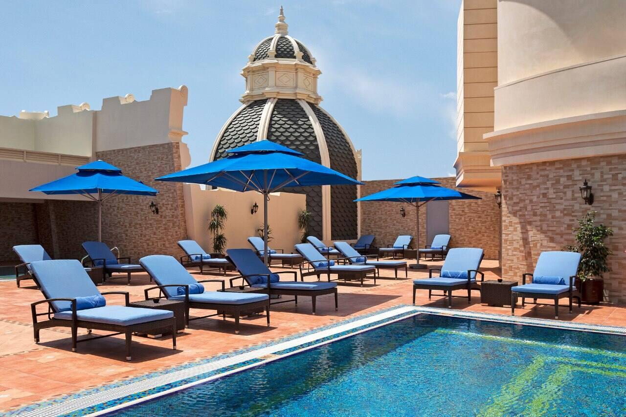 The rooftop pool and terrace with lounge chairs above Al Markaziyah