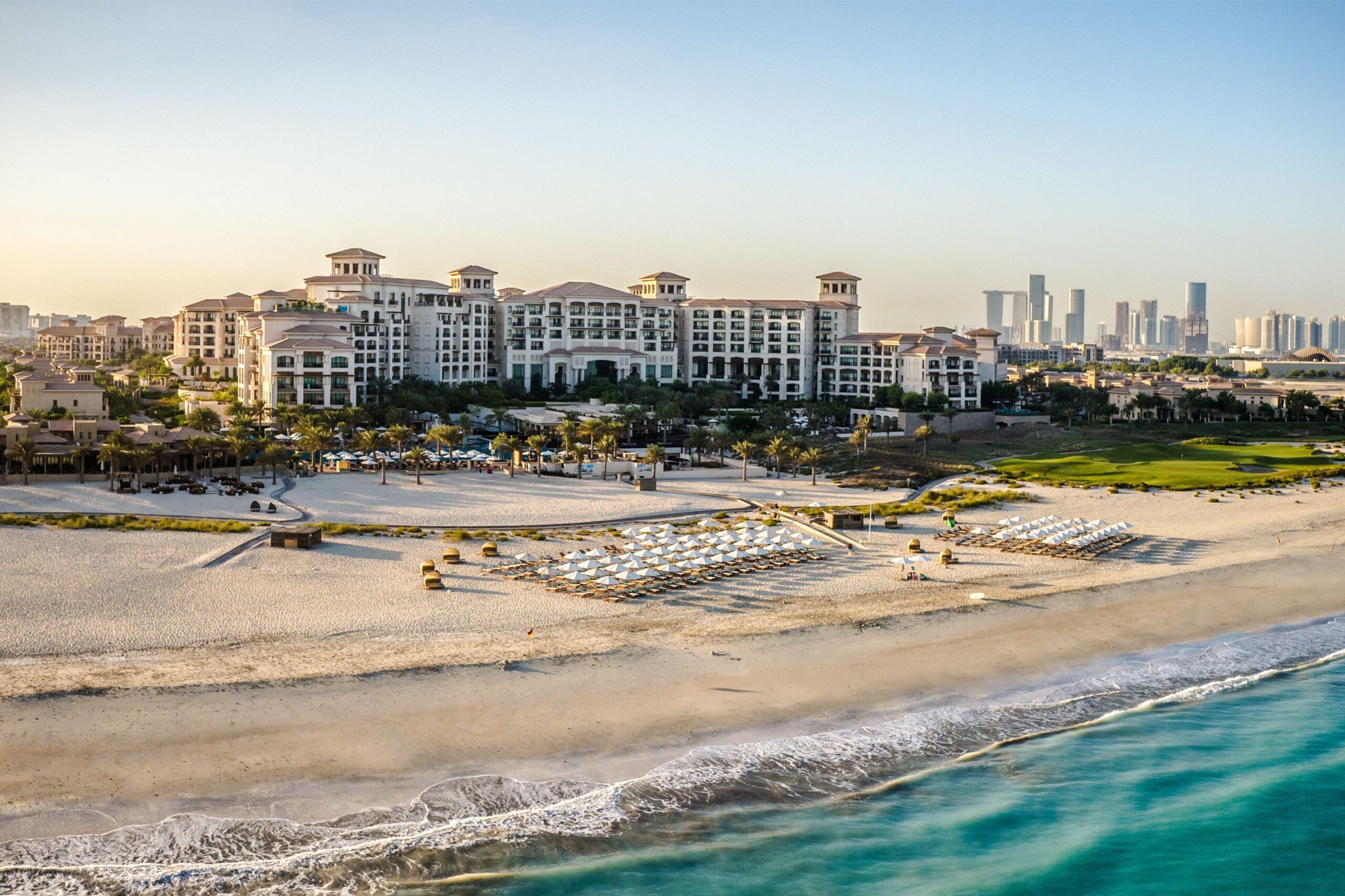 The protected white sand beach at Saadiyat with loungers and umbrellas