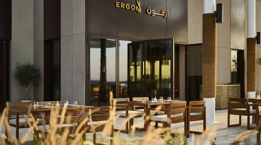 A dining terrace with garden seating at ERTH Abu Dhabi Hotel