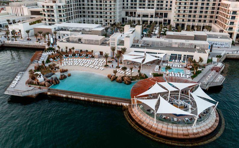 The private Yas Bay East Beach with loungers and umbrellas