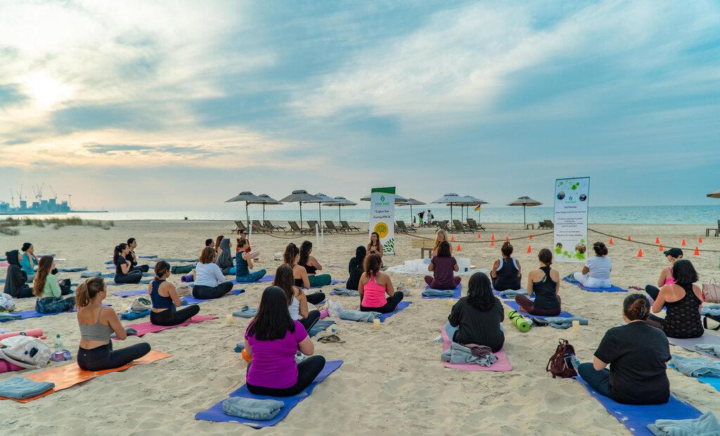 Beach yoga on the private stretch of Saadiyat shoreline