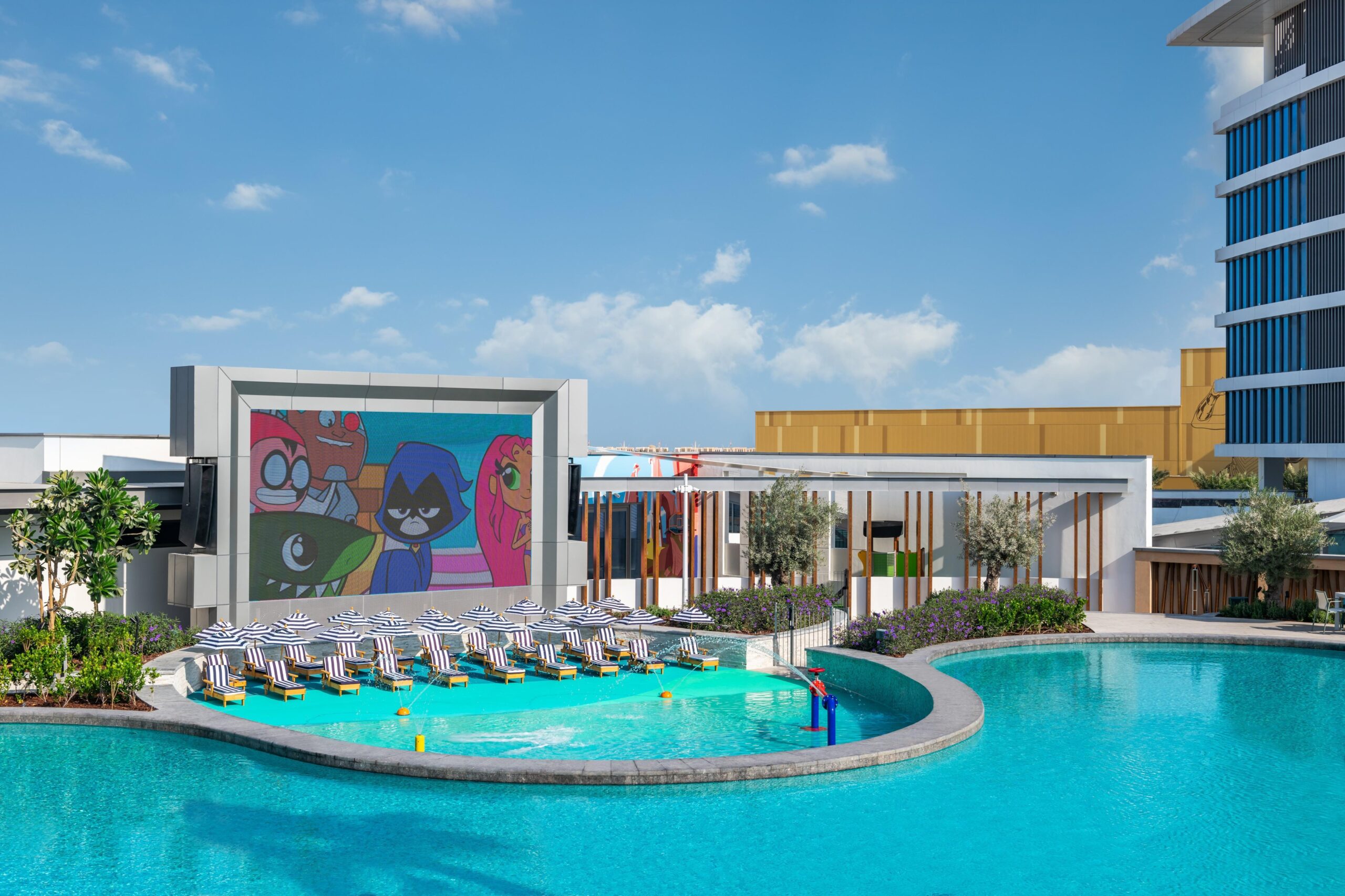 The heated main pool with the giant outdoor cinema screen above it