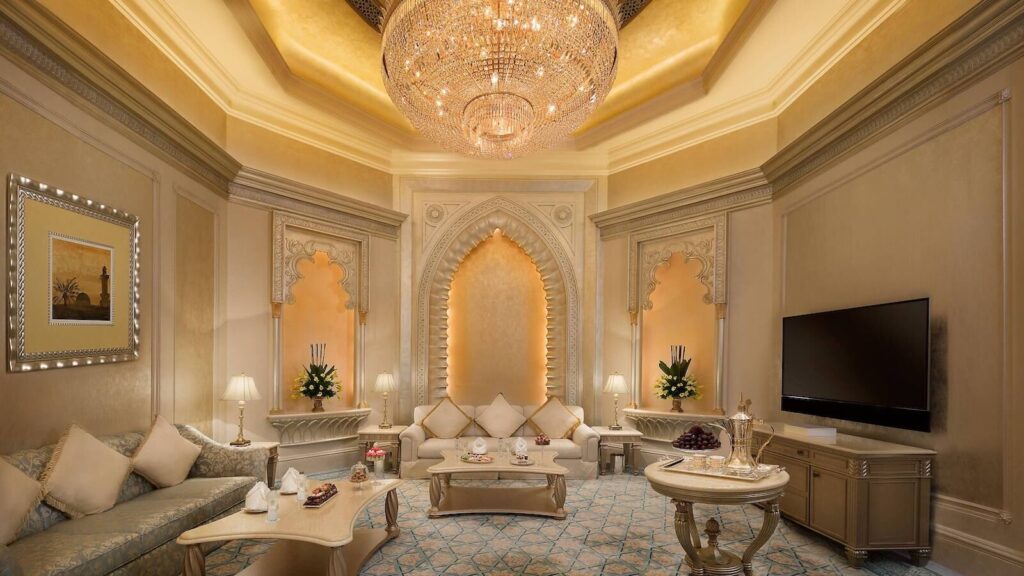 Elegant guest room at Emirates Palace Mandarin Oriental with neutral tones, teal accents and a private terrace.