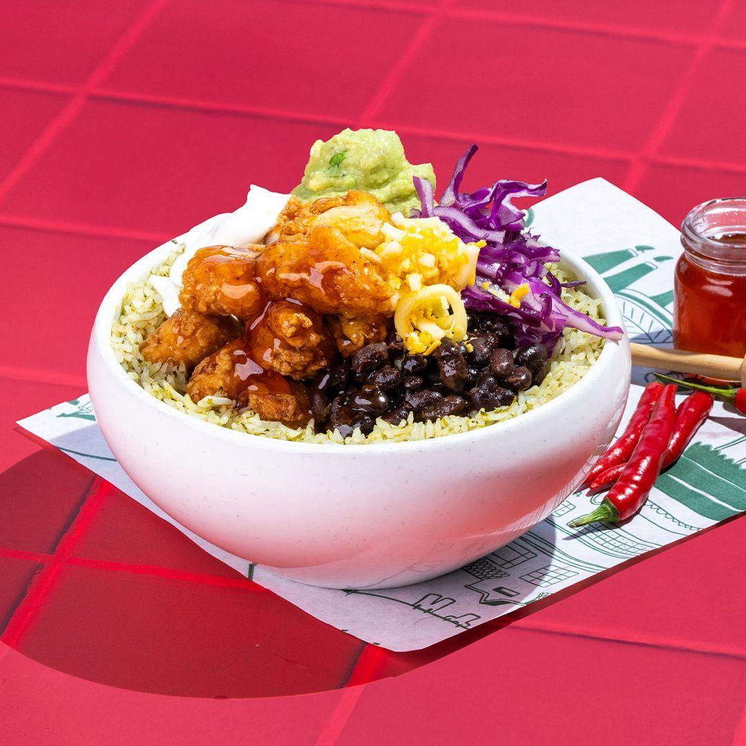 Freshly built burrito bowl with guacamole at Taqado Yas Mall