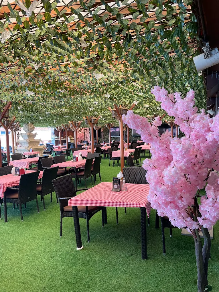Garden and family dining area at Villaggio Hotel and Resort Abu Dhabi